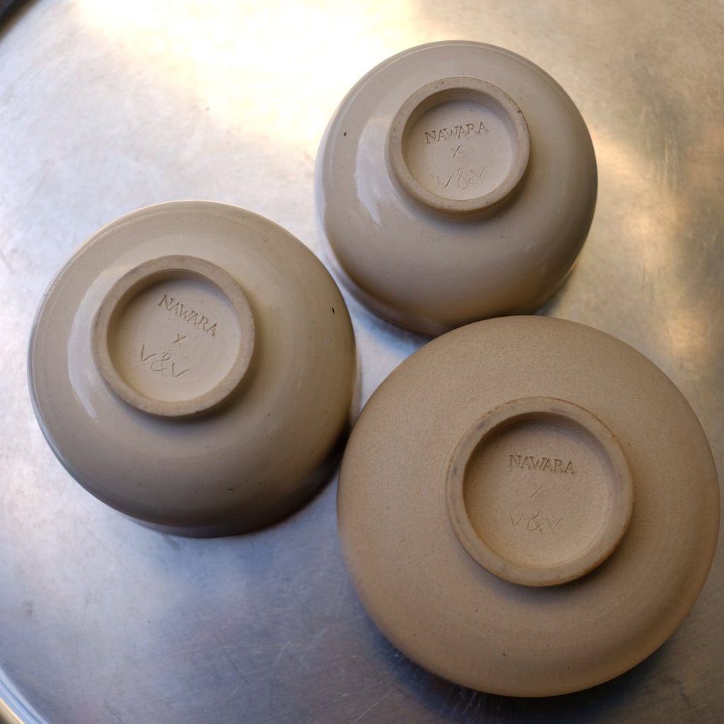 Three ceramic bowls on a metallic surface
