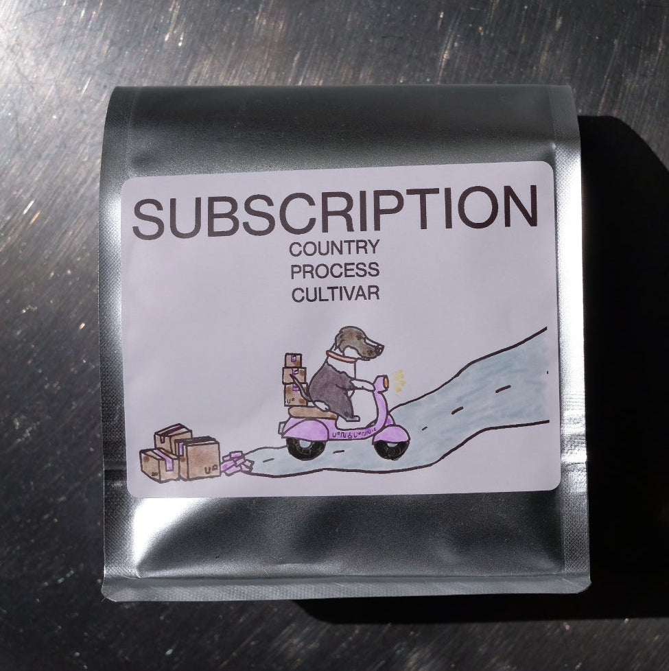 Silver coffee packaging with 'Subscription' text on a metallic surface