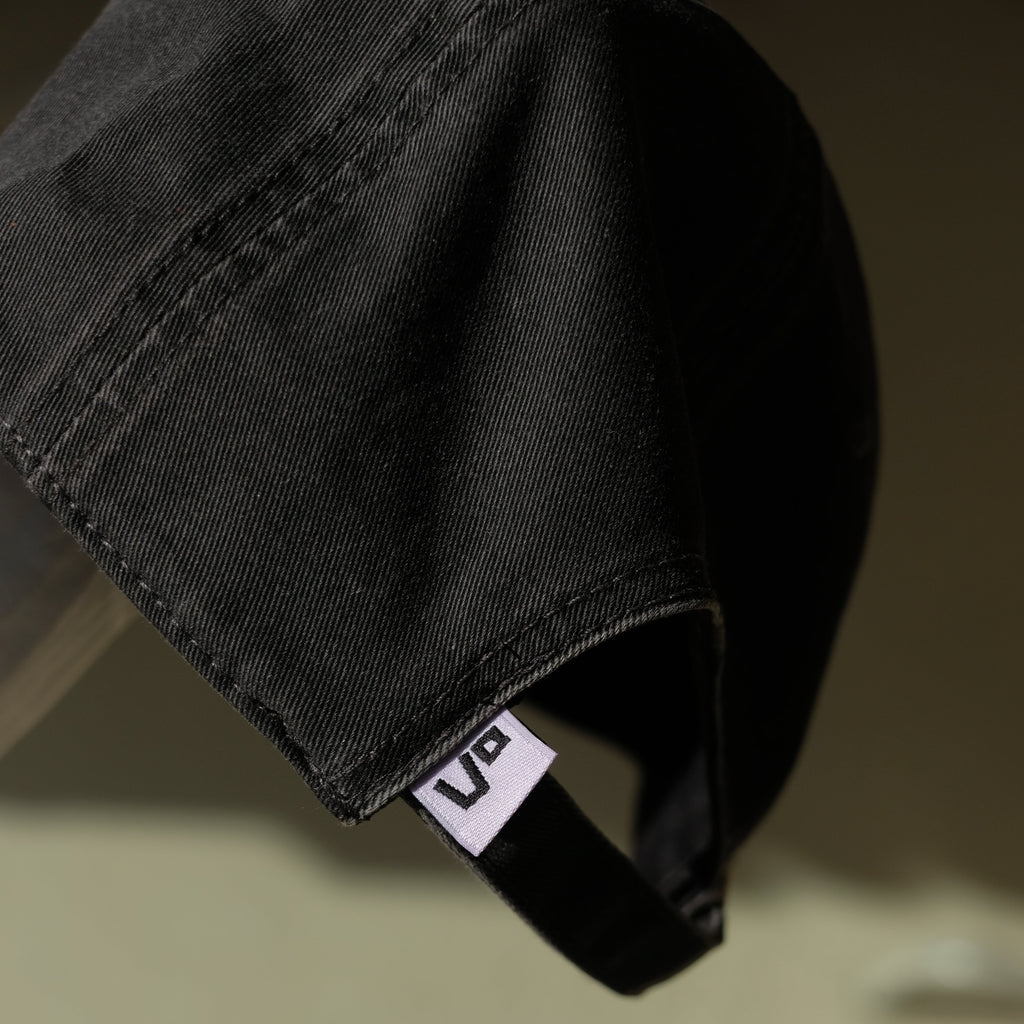Black cap with a visible brand logo on a blurred background