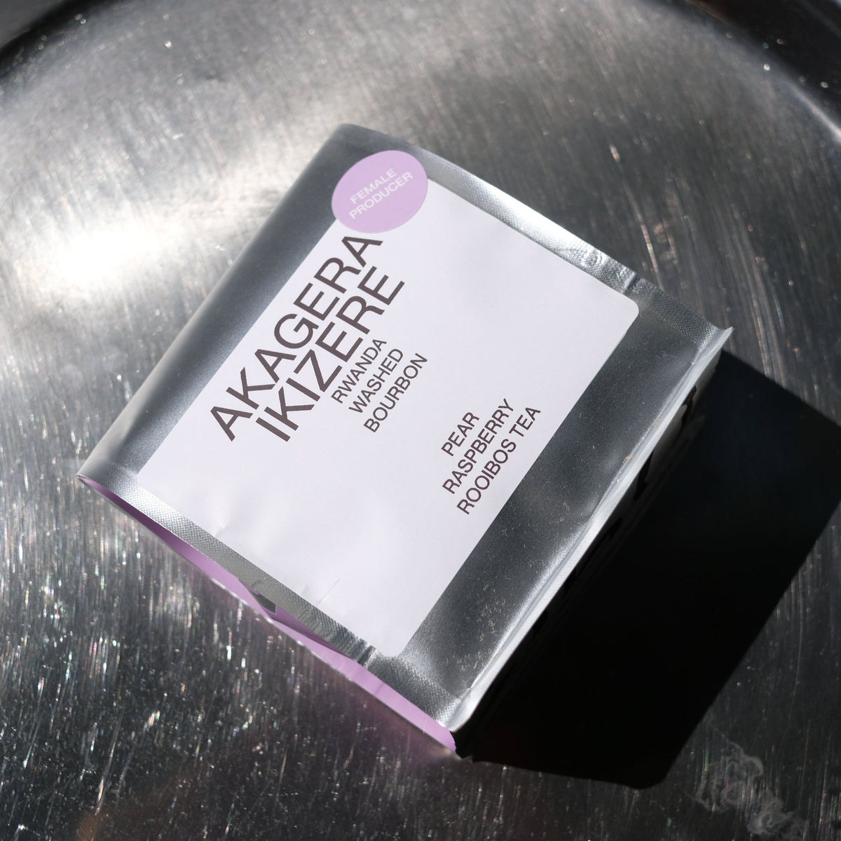 Product packaging labeled 'Akagera Ikizerere' on a metallic surface