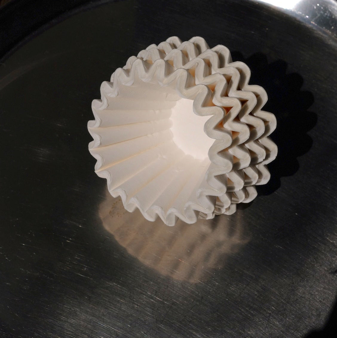 White paper filter on a metallic surface